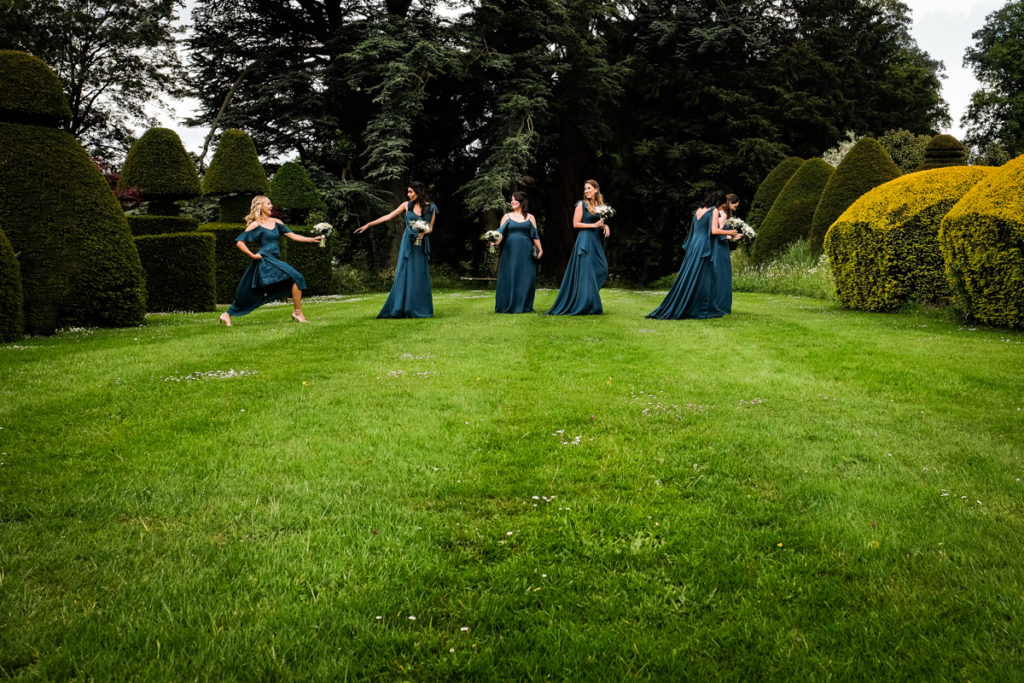 lake district documentary wedding photographer Askham Hall four bridesmaids walking