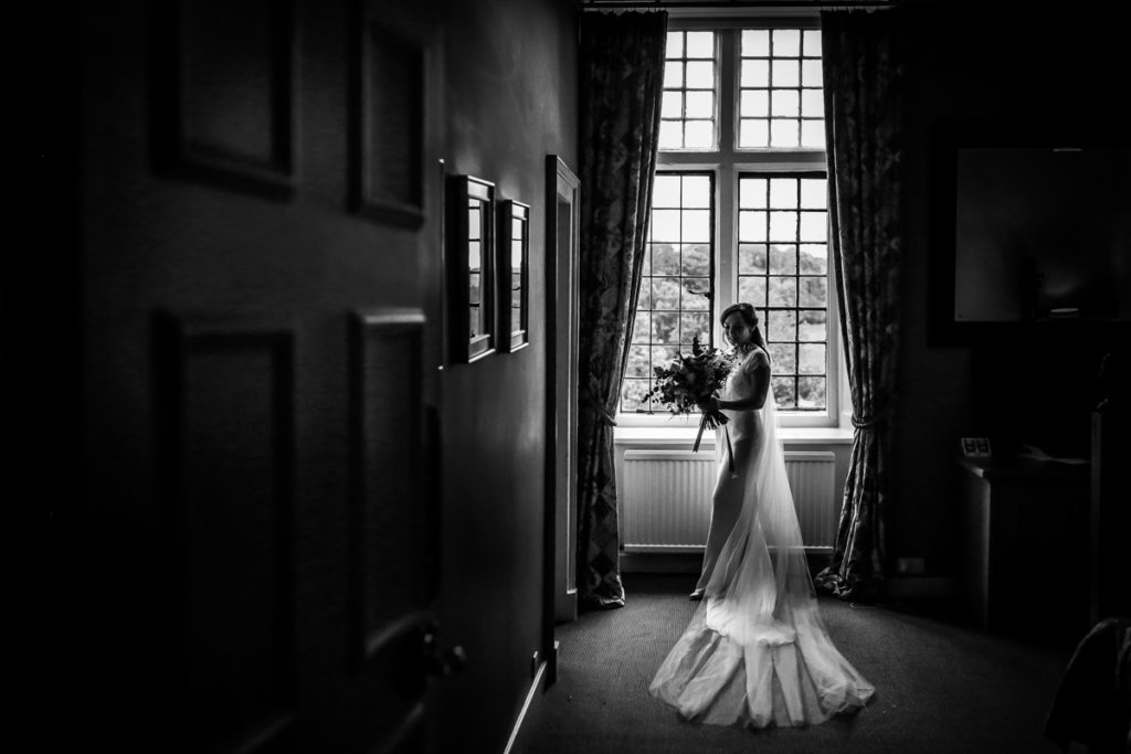 lake district documentary wedding photographer Askham Hall bride in window