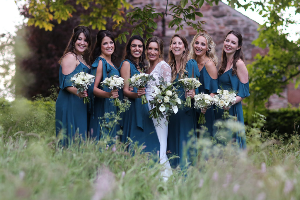 lake district documentary wedding photographer Askham Hall bride and bridesmaids in long grass