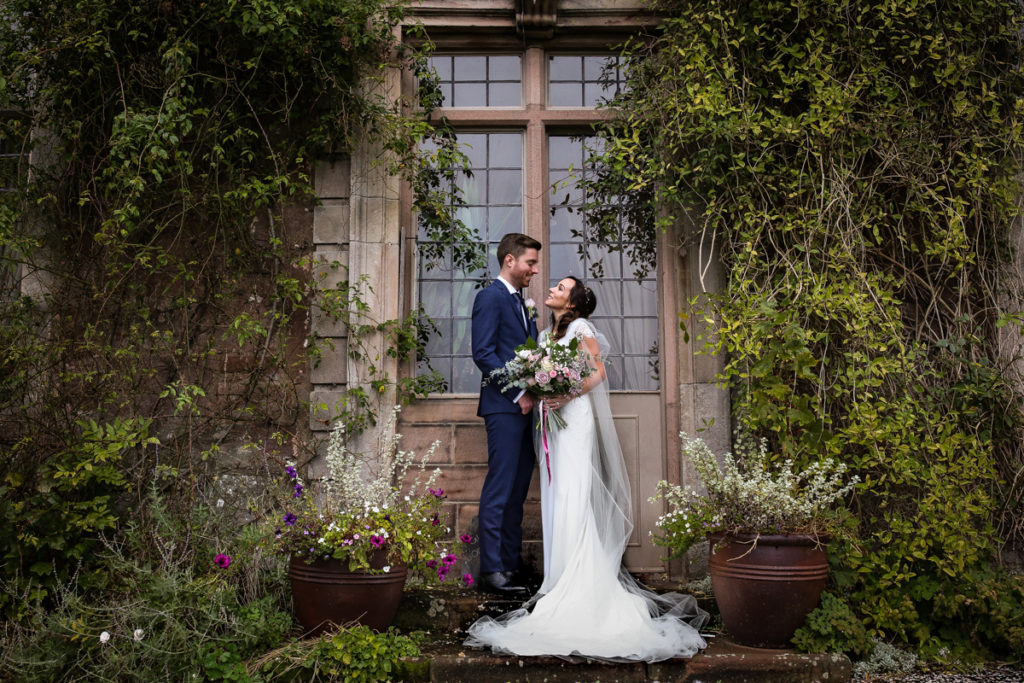 lake district documentary wedding photographer Askham Hall bride and groom portrait by window