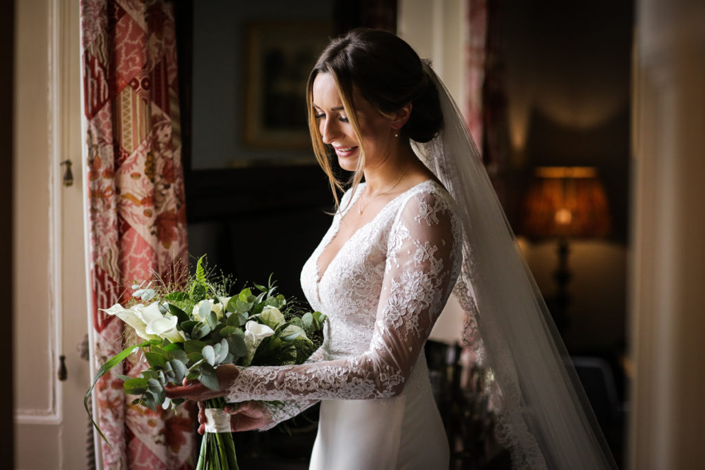 lake district documentary wedding photographer Askham Hall bridal portrait with flowers