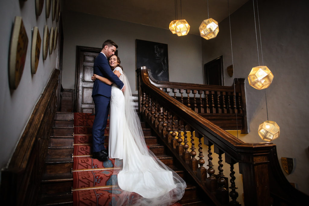 lake district documentary wedding photographer Askham Hall couple on the stairs