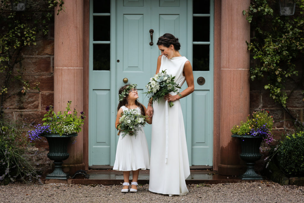 lake district documentary wedding photographer Rowley Estates bride and flower girl in door