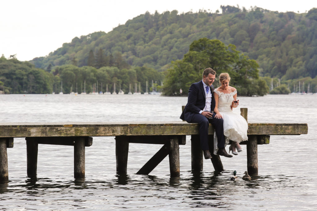 lake district documentary wedding photographer couple on jetty with duck