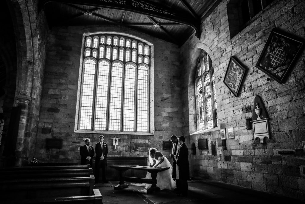 lake district documentary wedding photographer Church silhouette in church black and white