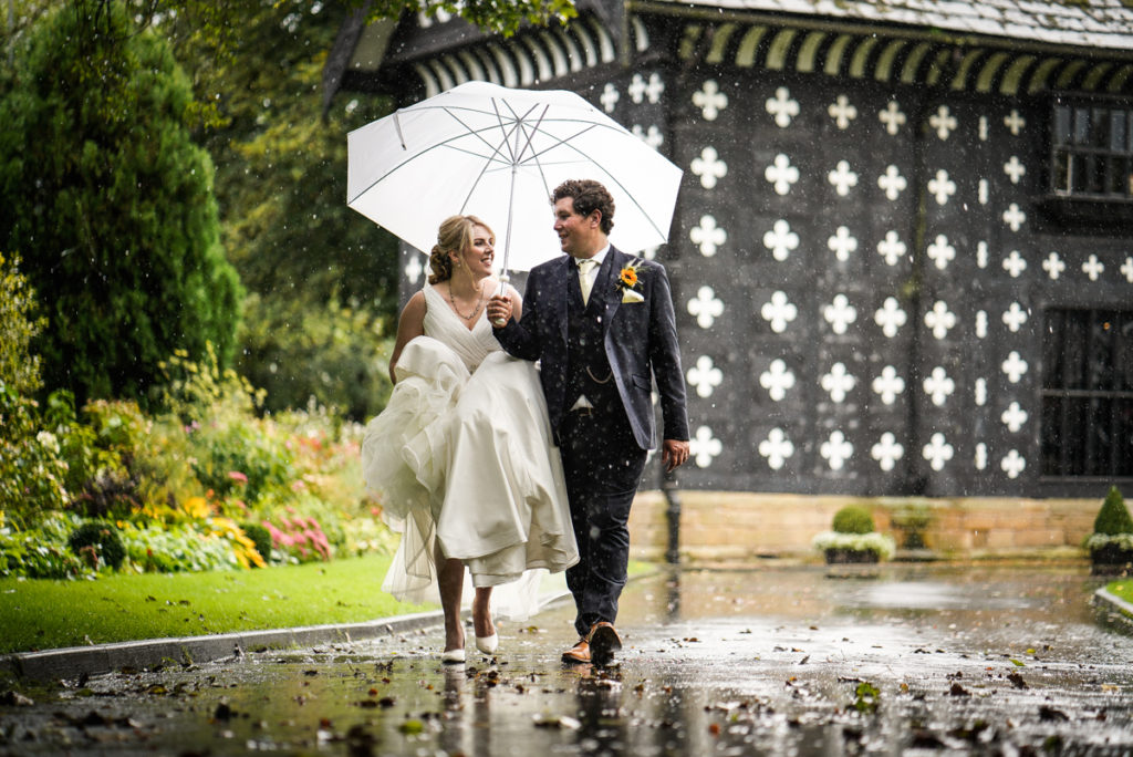 lake district documentary wedding photographer Samlesbury Hall couple in the rain