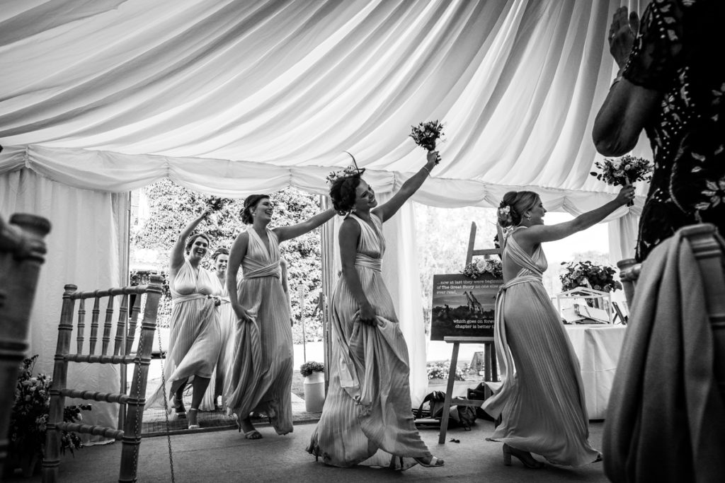 lake district documentary wedding photographer Low House bridesmaids entrance to the speeches black and white