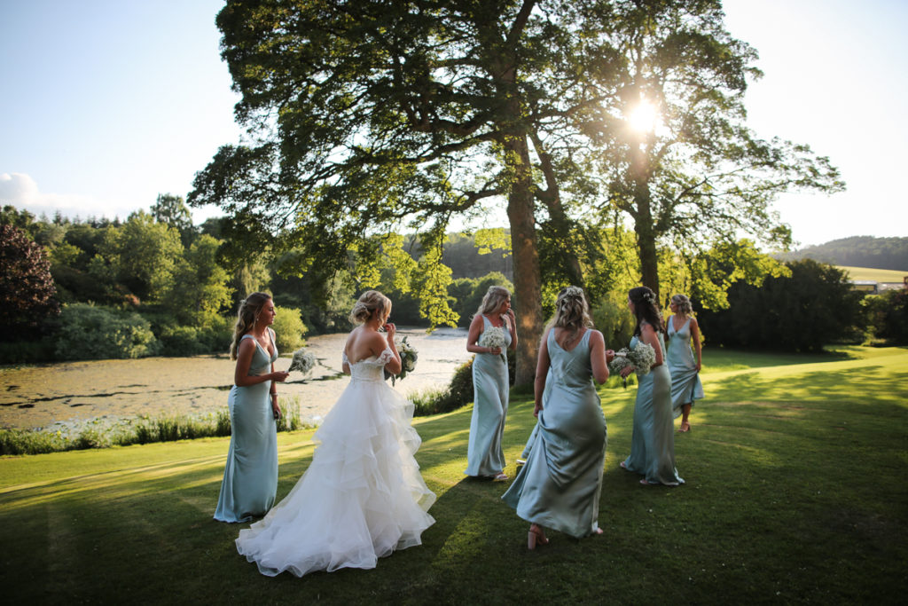 lake district documentary wedding photographer Greystoke Castle bridesmaids in the late summer sun with lake