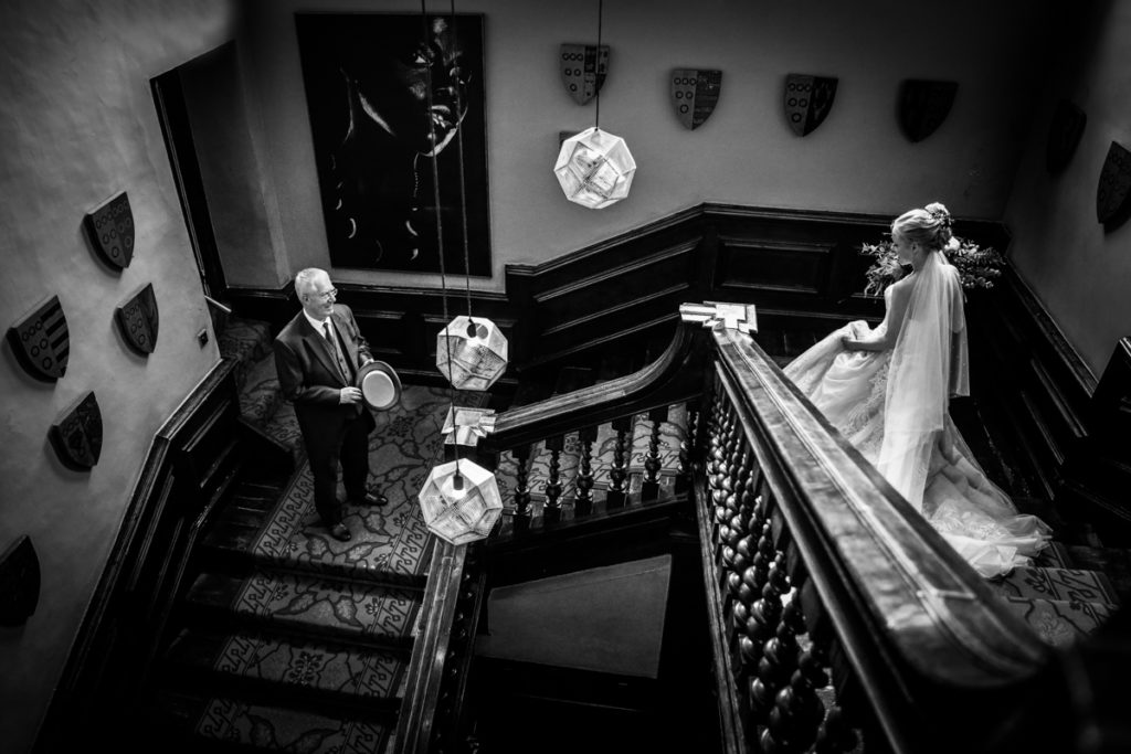 lake district documentary wedding photographer Askham Hall bride and father on the stairs