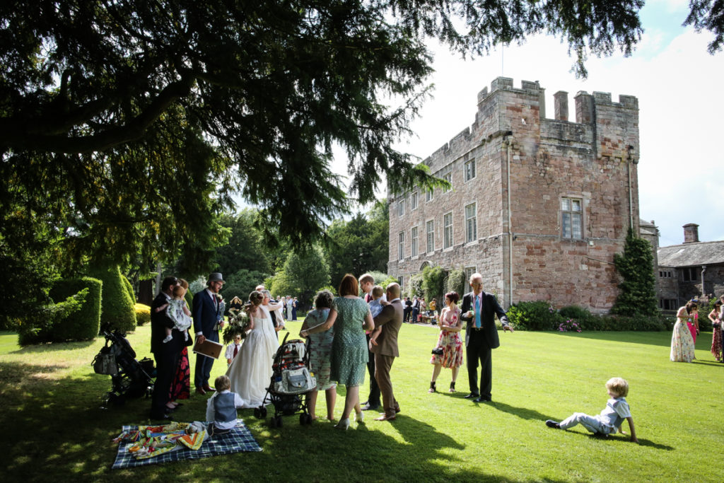 lake district documentary wedding photographer Askham Hall guests on the lawn