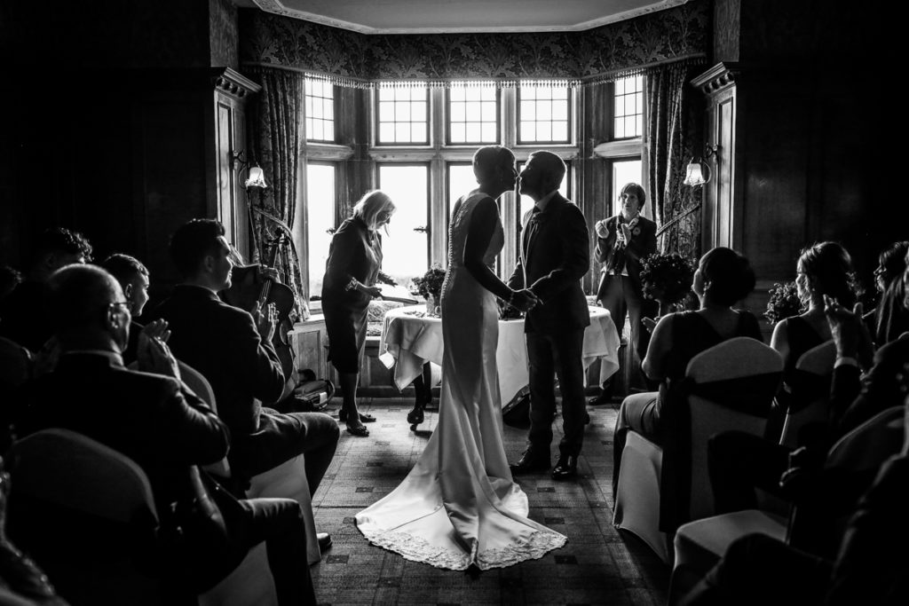 lake district documentary wedding photographer Holbeck Ghyll couple kissing in black and white