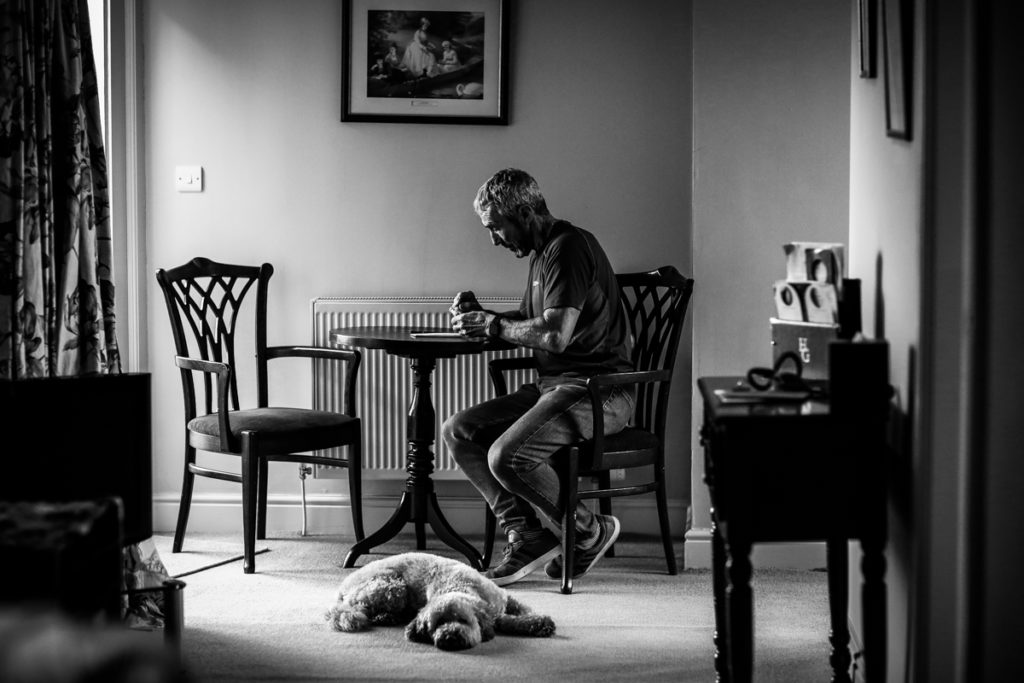 lake district documentary wedding photographer groom writing his speech in black and white