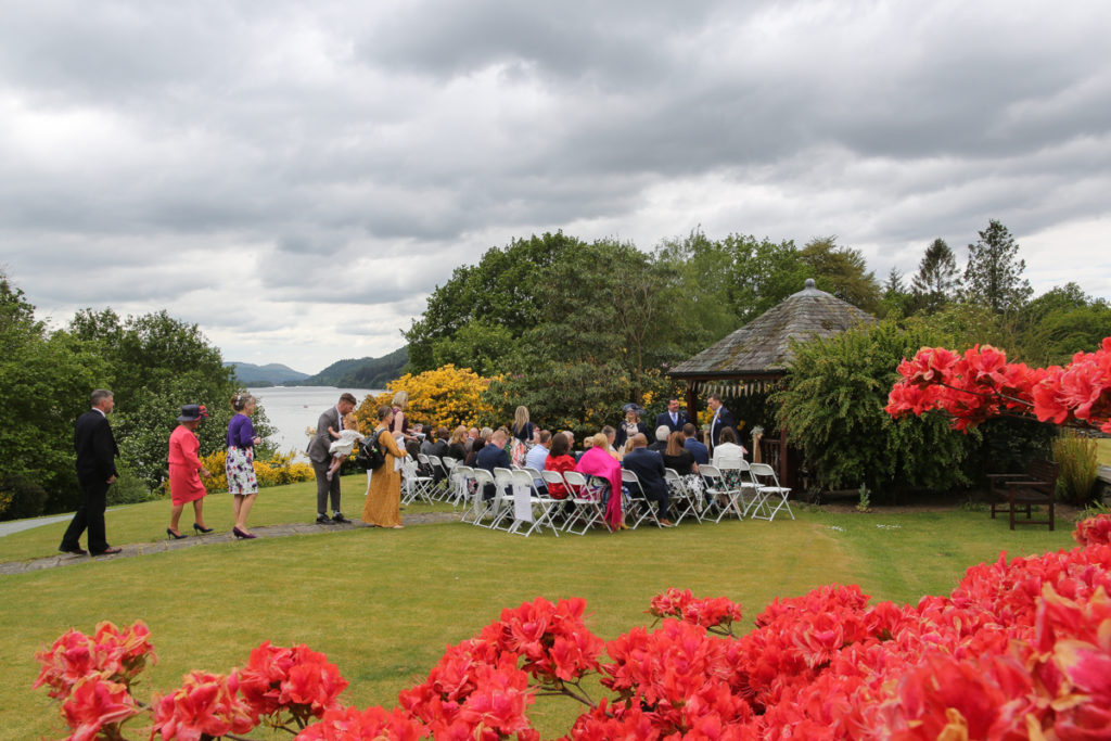 lake district documentary wedding photographer Cragwood wedding guests in the pretty summer gardens