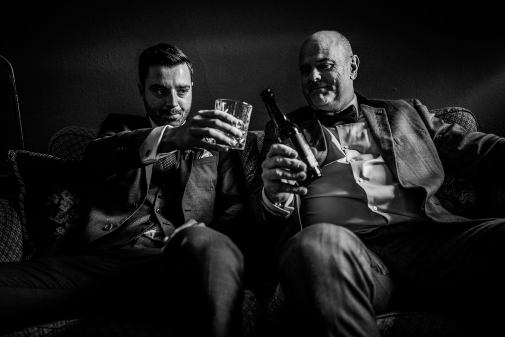 lake district documentary wedding photographer Askham hall two men drinking in black and white