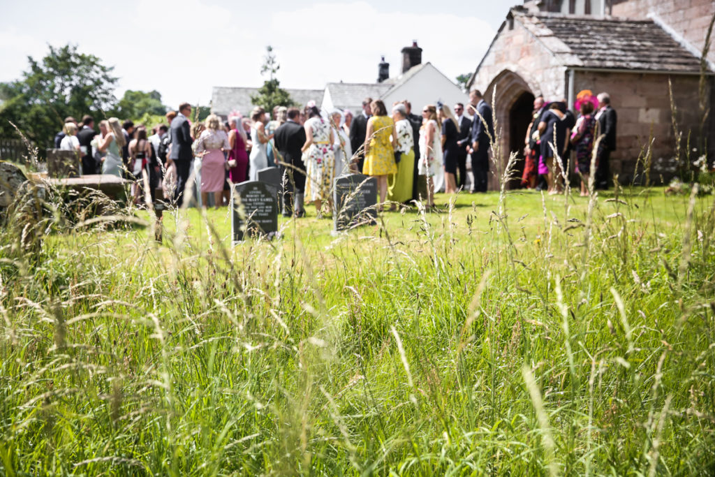 lake district documentary wedding photographer wedding guests outside the church