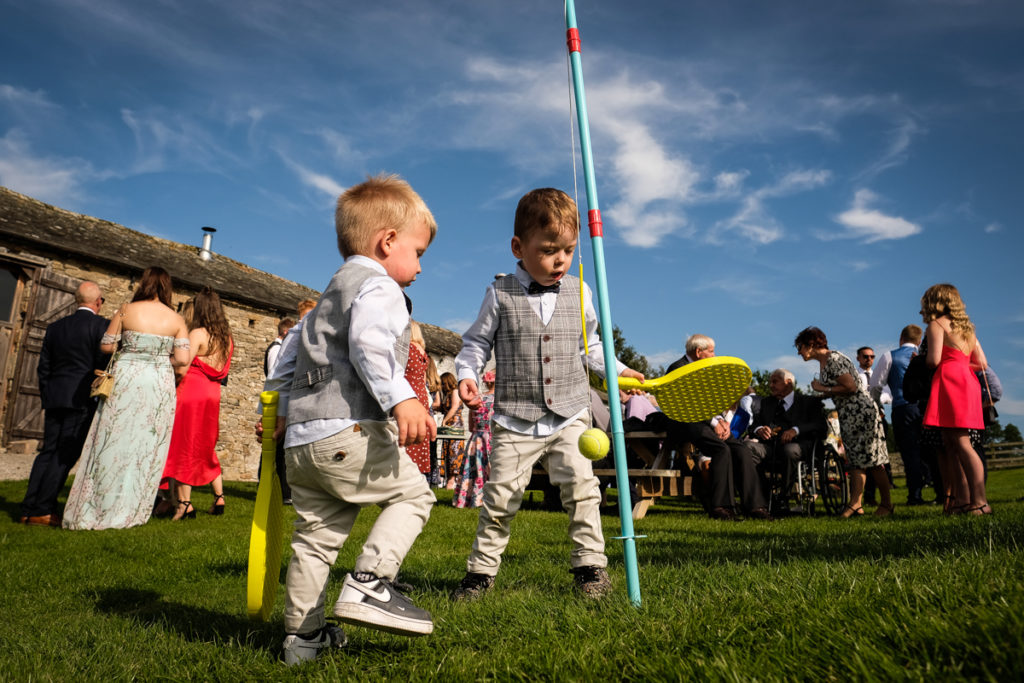 lake district documentary wedding photographer kids playing swing ball at a wedding