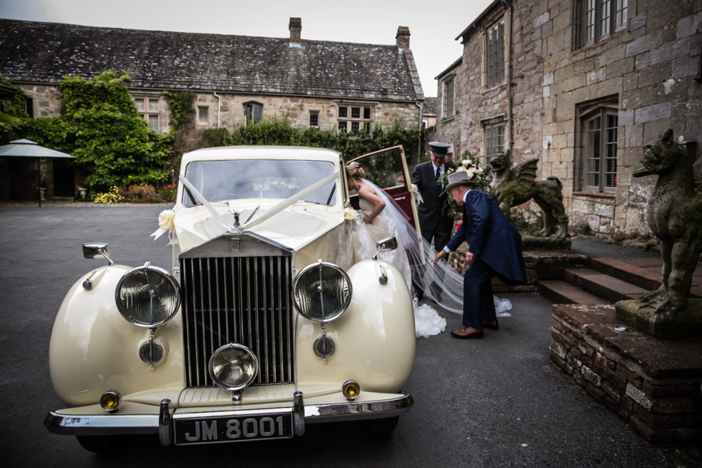 lake district documentary wedding photographer Askham Hall bride leaving in vintage rolls royce