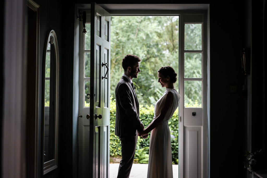 lake district documentary wedding photographer Melmerby Hall couple in door silhouette