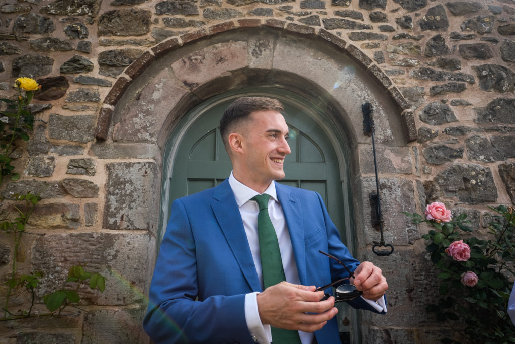 lake district documentary wedding photographer groom in door