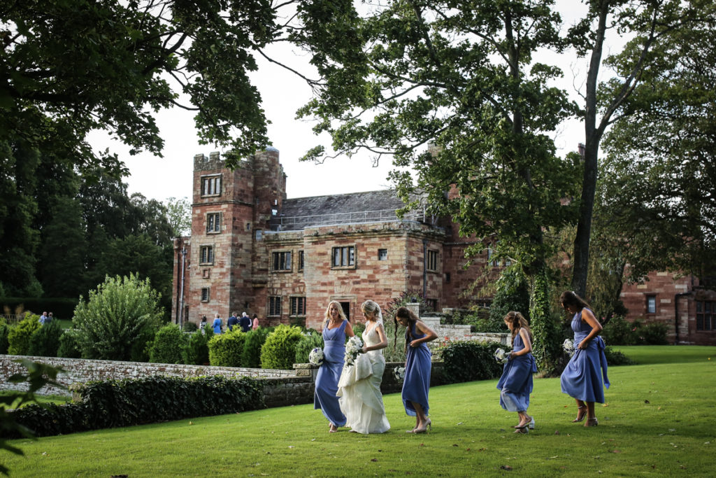 lake district documentary wedding photographer Dalston Hall bride and bridesmaids walking