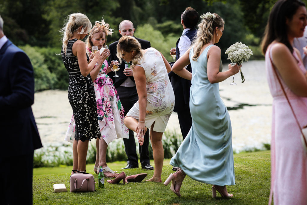 lake district documentary wedding photographer Greystoke Castle wedding guests on lawn