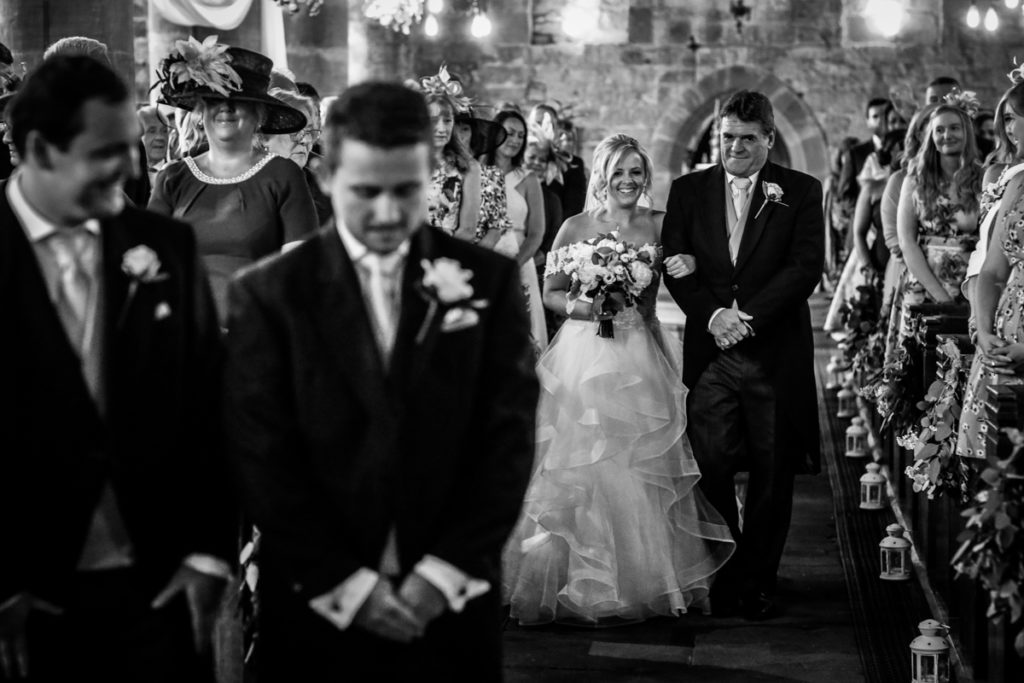 lake district documentary wedding photographer church bride and father walking up the aisle