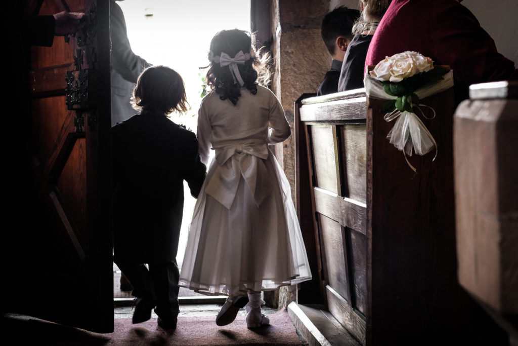 lake district documentary wedding photographer flower girl and page boy in church door