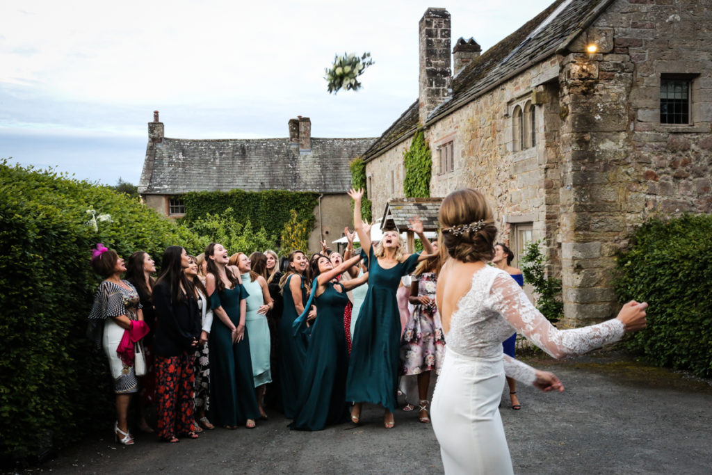 lake district documentary wedding photographer Askham Hall throwing the bouquet